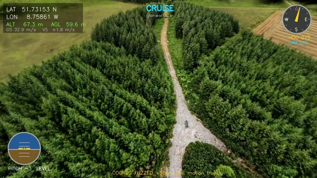 Rendered frame cruising over a plantation edge and forest track, with a flight HUD.