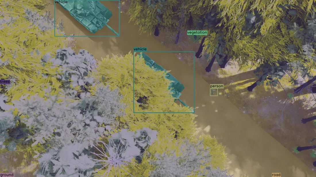 Overhead view of armoured vehicles segmented among snow patches and dense foliage.